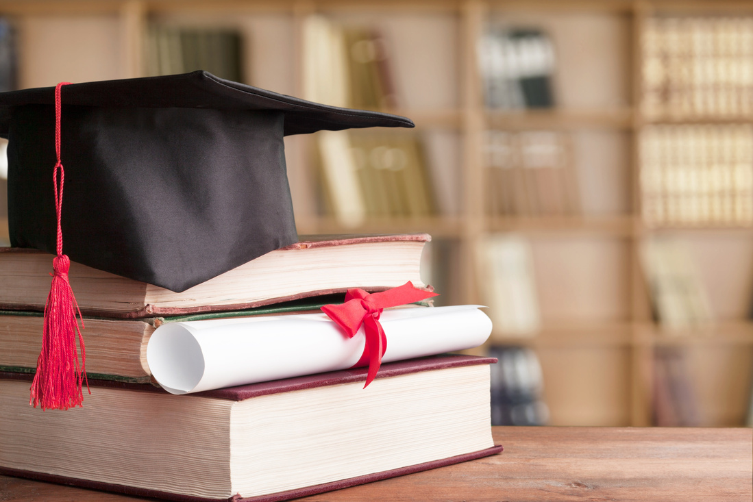 Graduation Cap, Hat with Degree Paper on Wood Table Graduation Concept.